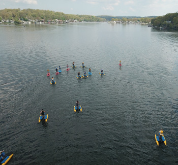 A group of adventurers riding hydrobikes and paddleboards on Lake Hopatcong.