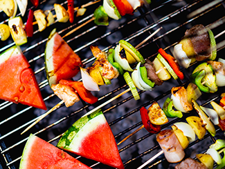 Watermelon and kabobs on a grill