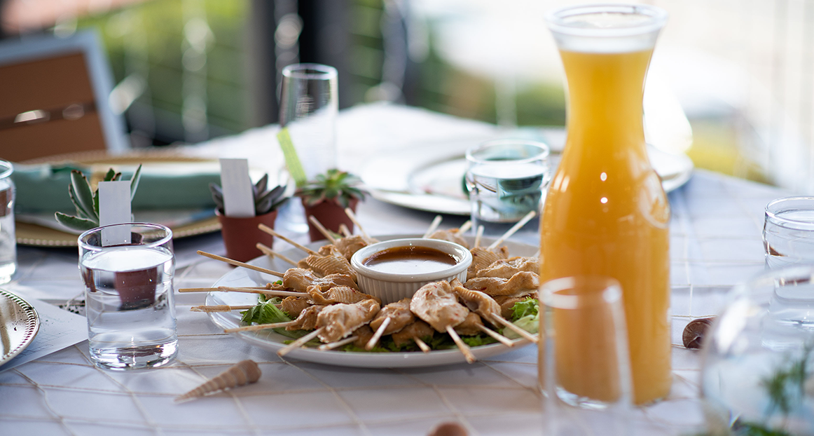 Table with orange juice and appetizers